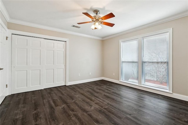 unfurnished bedroom with ceiling fan, crown molding, dark hardwood / wood-style flooring, and multiple windows