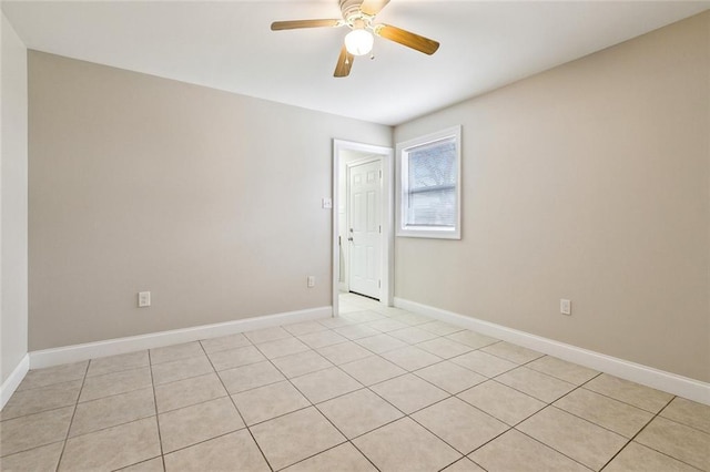 tiled spare room featuring ceiling fan