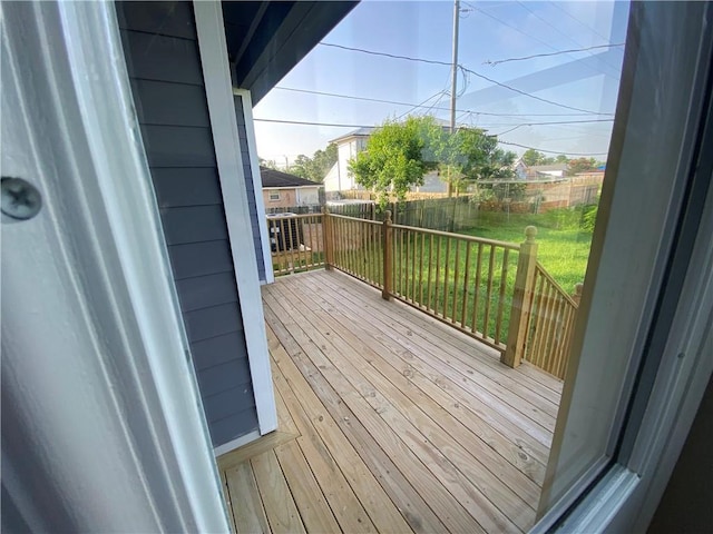 deck featuring a lawn and fence