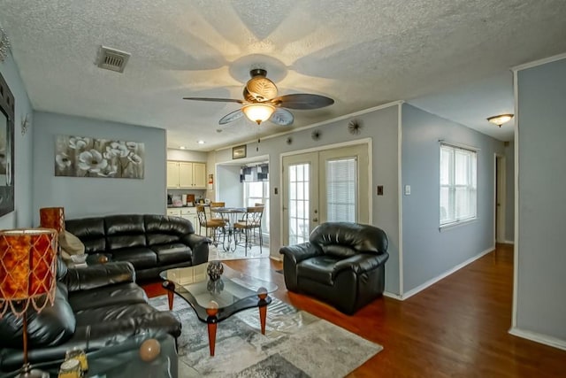 living room with hardwood / wood-style floors, french doors, ceiling fan, and plenty of natural light