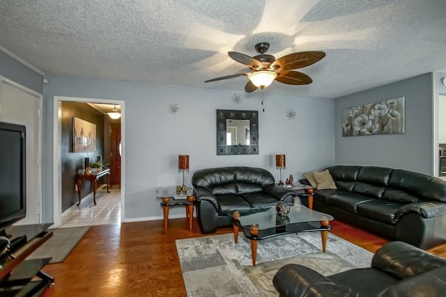 living room with ceiling fan, a textured ceiling, and hardwood / wood-style flooring