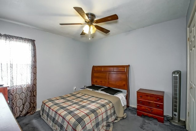 carpeted bedroom with ceiling fan and a closet