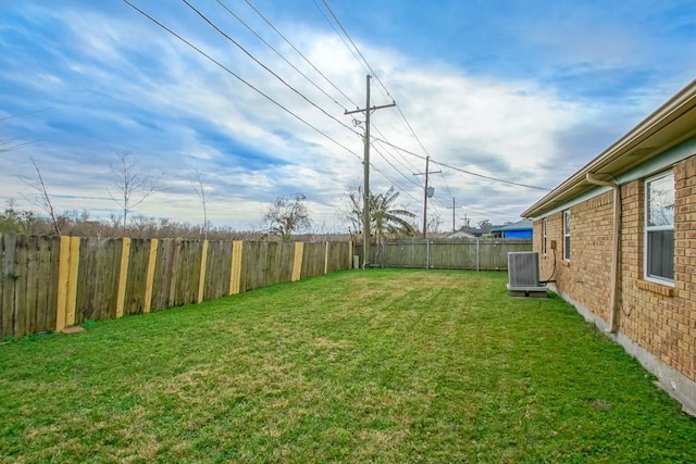 view of yard featuring central air condition unit