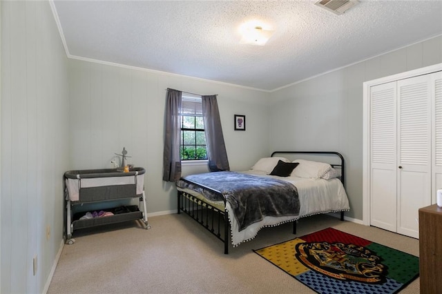 carpeted bedroom featuring a textured ceiling and ornamental molding