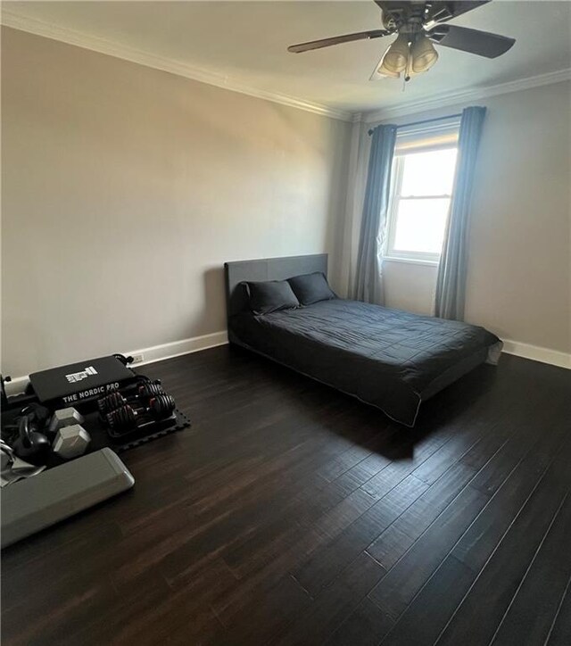 bedroom featuring ceiling fan, dark hardwood / wood-style floors, and crown molding