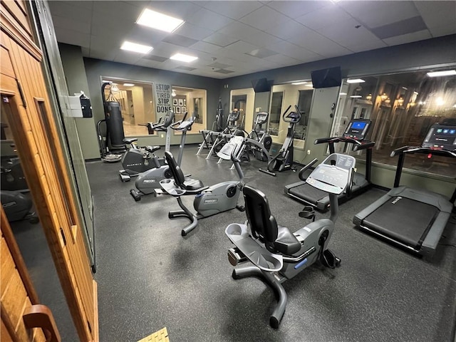 gym with a paneled ceiling