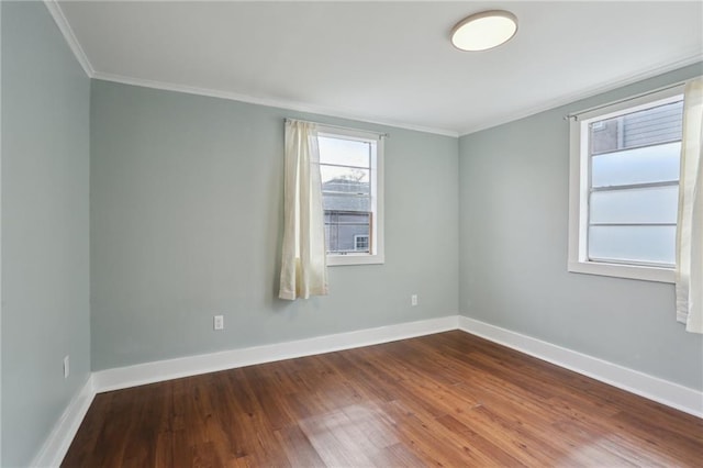 empty room featuring wood-type flooring and ornamental molding