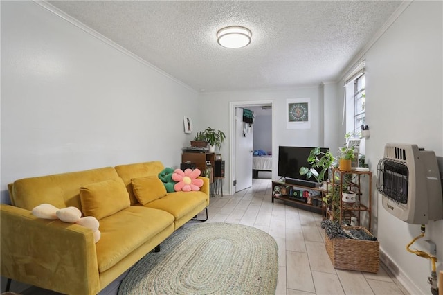 living room featuring heating unit, ornamental molding, and a textured ceiling