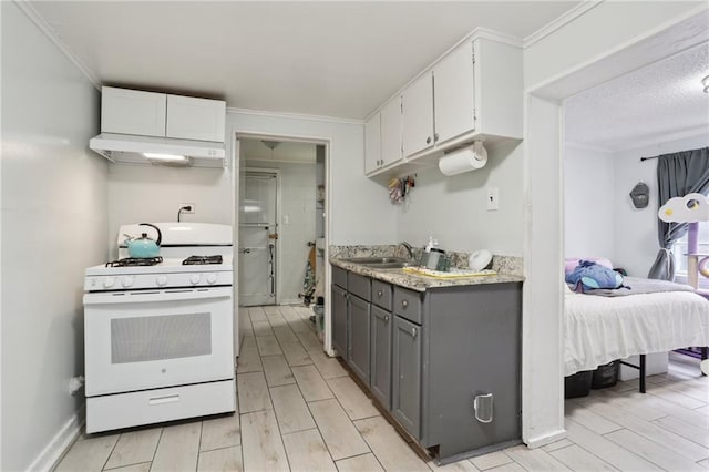 kitchen with white cabinetry, sink, gray cabinetry, white range with gas stovetop, and crown molding