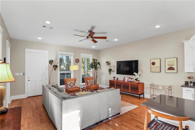 living room featuring ceiling fan and light wood-type flooring