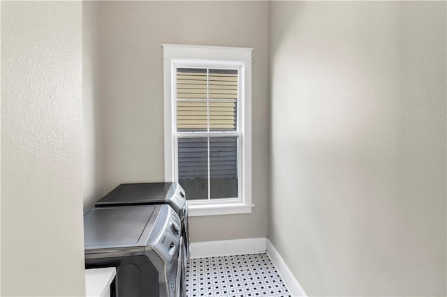 clothes washing area featuring independent washer and dryer