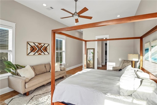 bedroom with lofted ceiling and wood-type flooring