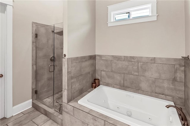 bathroom featuring tile patterned flooring and shower with separate bathtub