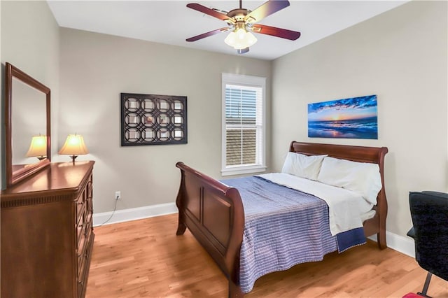 bedroom with ceiling fan and light hardwood / wood-style flooring