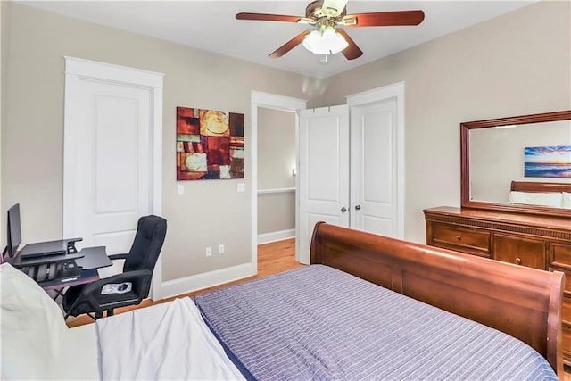 bedroom with ceiling fan, light hardwood / wood-style floors, and a closet