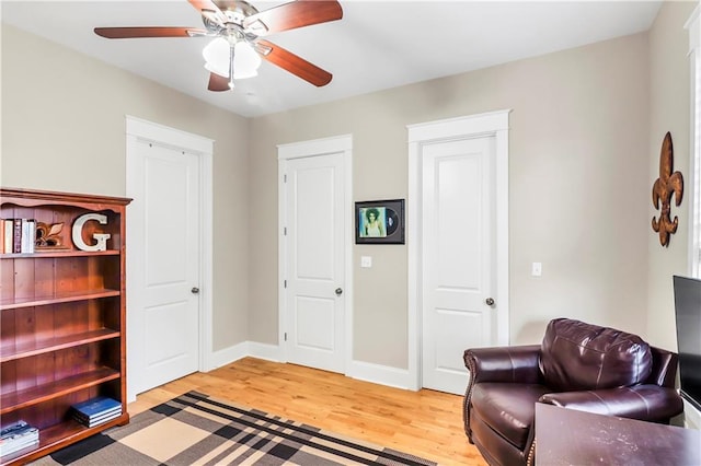 sitting room featuring ceiling fan and wood-type flooring