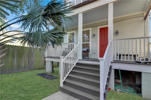 property entrance with a lawn