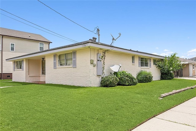 rear view of property with a lawn