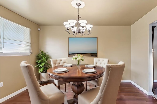 dining room featuring a notable chandelier and dark hardwood / wood-style floors