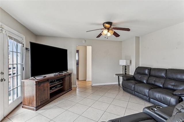 living room featuring light tile patterned flooring, a wealth of natural light, ceiling fan, and french doors