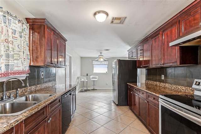 kitchen featuring sink, backsplash, light tile patterned flooring, and appliances with stainless steel finishes