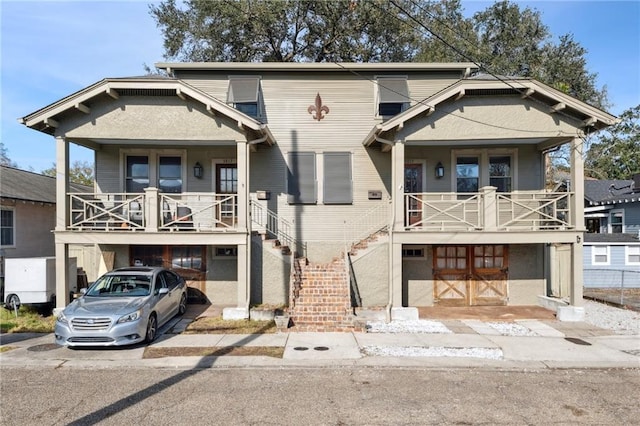 view of front of house featuring a balcony, a garage, and covered porch