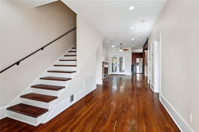 foyer featuring french doors, ceiling fan, and dark hardwood / wood-style flooring