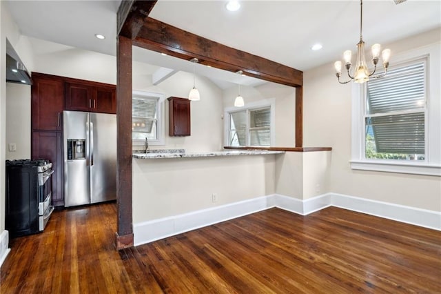 kitchen featuring light stone counters, decorative light fixtures, an inviting chandelier, beam ceiling, and appliances with stainless steel finishes