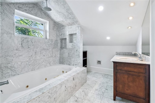 bathroom featuring lofted ceiling, a relaxing tiled tub, and vanity