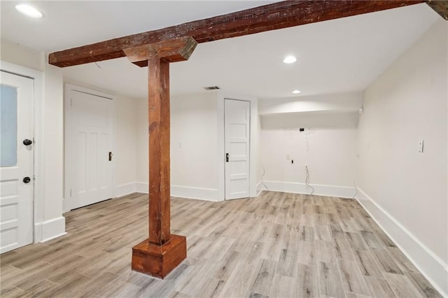 basement with light hardwood / wood-style floors