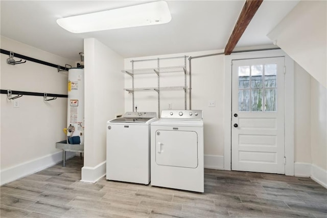 washroom featuring light hardwood / wood-style floors, washing machine and dryer, and water heater