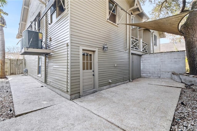 view of side of home featuring a patio and central AC unit