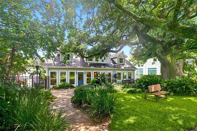 31 Heron St, New Orleans, LA 70124 - rear view of property featuring a lawn