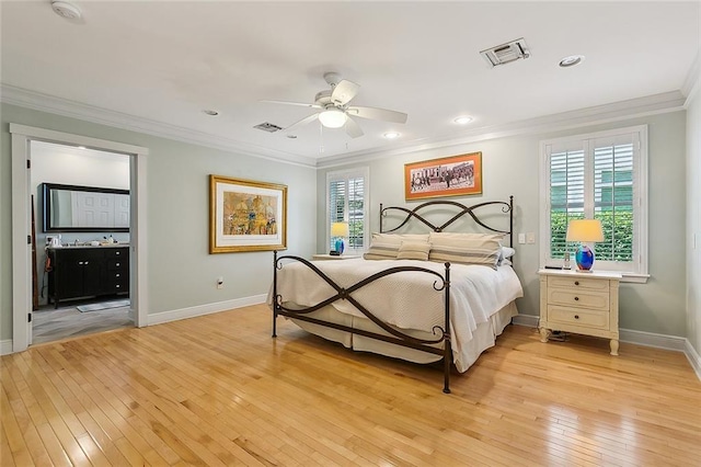 bedroom featuring light wood-type flooring, ceiling fan, ensuite bathroom, and crown molding