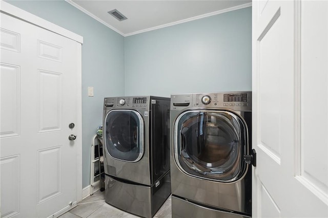 laundry room with separate washer and dryer, light tile patterned floors, and ornamental molding