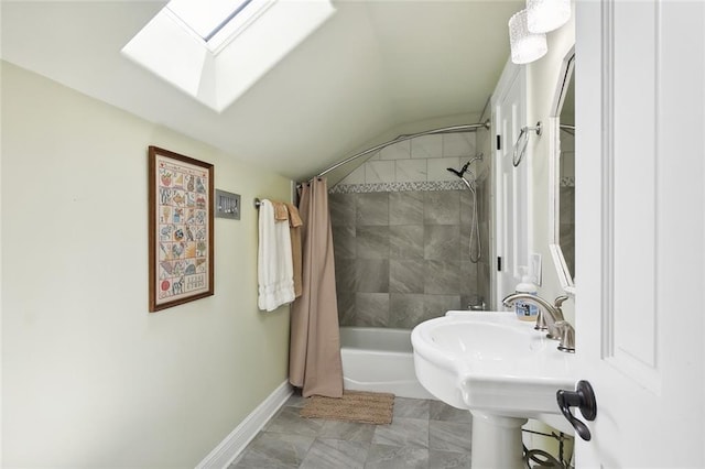 bathroom with lofted ceiling with skylight and shower / bath combo with shower curtain