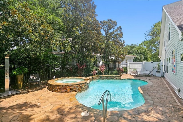 view of swimming pool with a patio area and an in ground hot tub