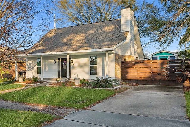 view of front of home featuring a front yard and a porch