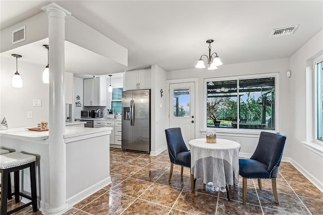 dining room featuring sink and a notable chandelier