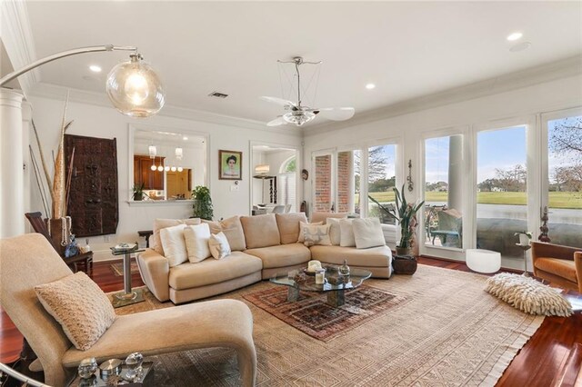 living room featuring crown molding, hardwood / wood-style flooring, and decorative columns