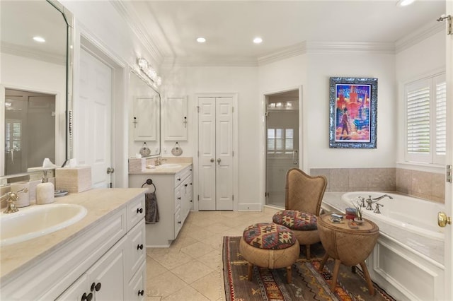 bathroom featuring vanity, tile patterned flooring, ornamental molding, and a bathing tub