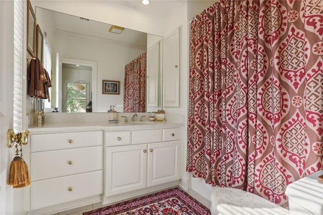 bathroom featuring crown molding and vanity