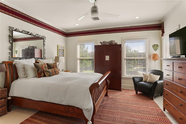 carpeted bedroom with crown molding and ceiling fan