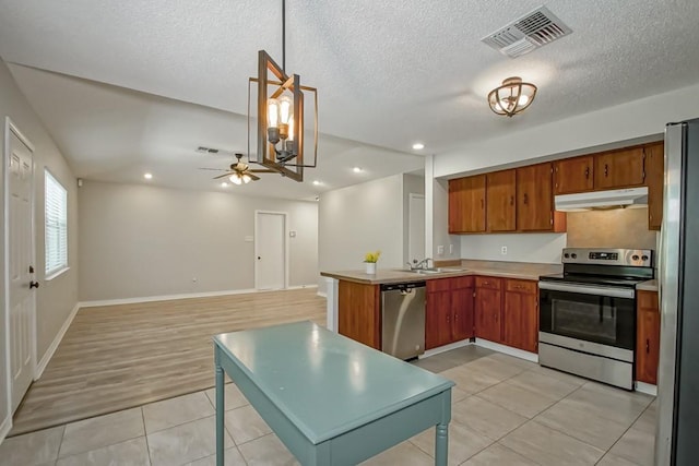 kitchen with decorative light fixtures, stainless steel appliances, light tile patterned floors, ceiling fan, and sink