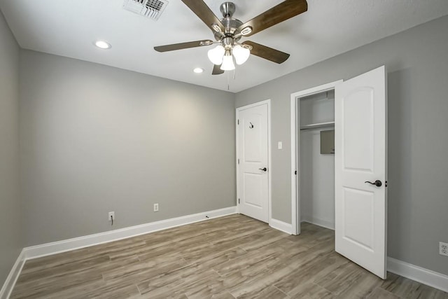 unfurnished bedroom with a closet, ceiling fan, and wood-type flooring