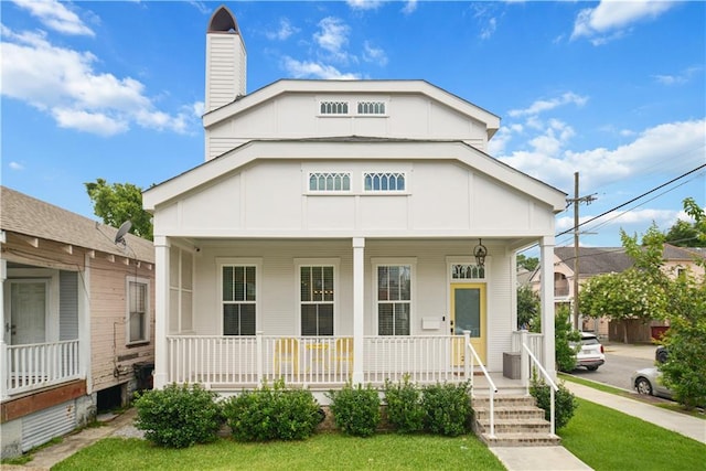 201 S Cortez St, New Orleans, LA 70119 - view of front of house with a porch and a chimney