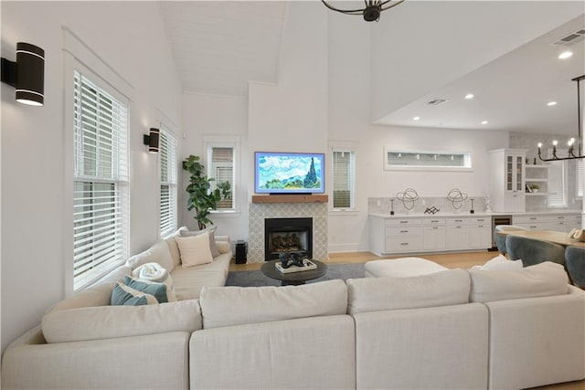 201 S Cortez St, New Orleans, LA 70119 - living room with beverage cooler, a tile fireplace, a chandelier, healthy amount of natural light, and recessed lighting