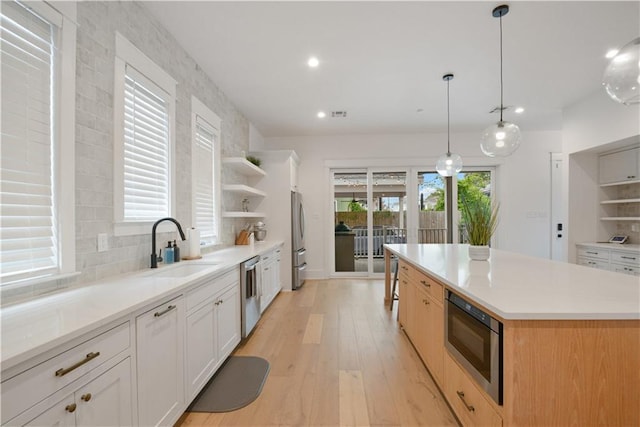 201 S Cortez St, New Orleans, LA 70119 - kitchen featuring open shelves, appliances with stainless steel finishes, light wood-style floors, recessed lighting, and a kitchen island