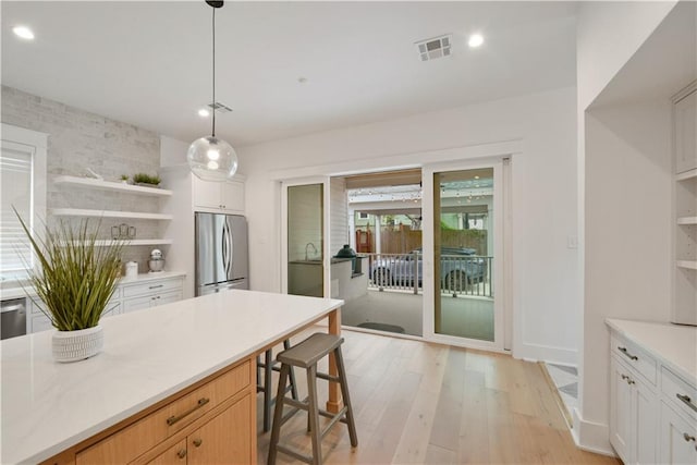 201 S Cortez St, New Orleans, LA 70119 - kitchen with open shelves, freestanding refrigerator, light wood-type flooring, recessed lighting, and light countertops
