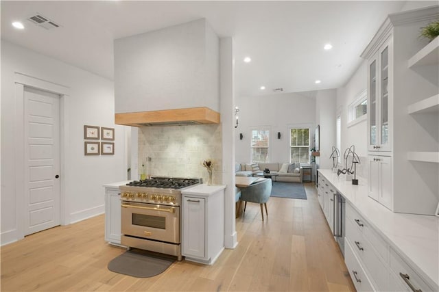 201 S Cortez St, New Orleans, LA 70119 - kitchen with stainless steel range, open shelves, light wood-type flooring, backsplash, and recessed lighting